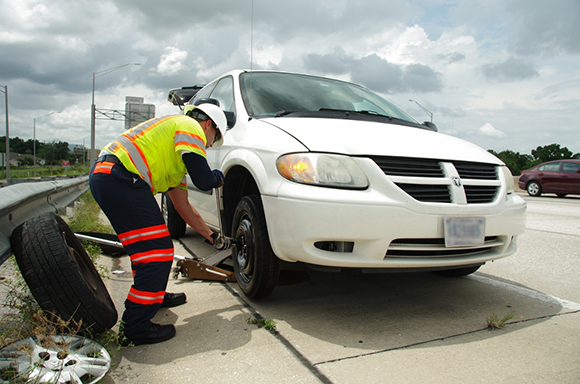 Road Rangers performing their services, changing a tire.