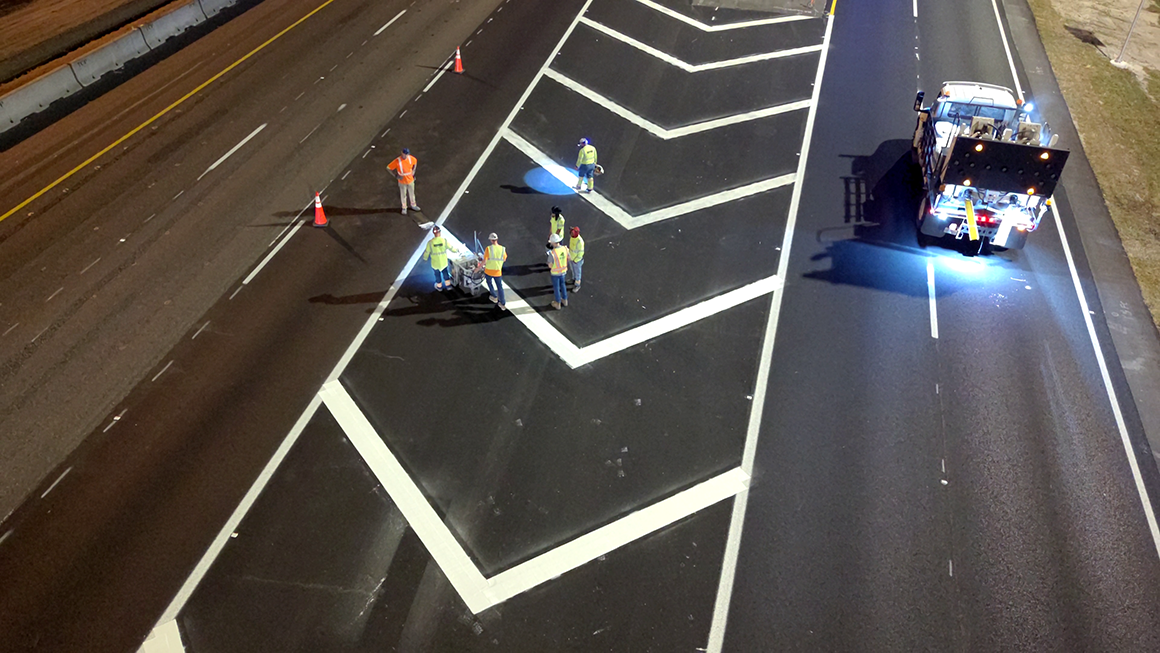 Workers paint lines on S.R. 528 using Thermoplastic paint